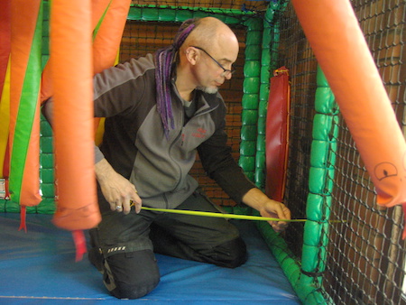 Matthew measuring a children's play system