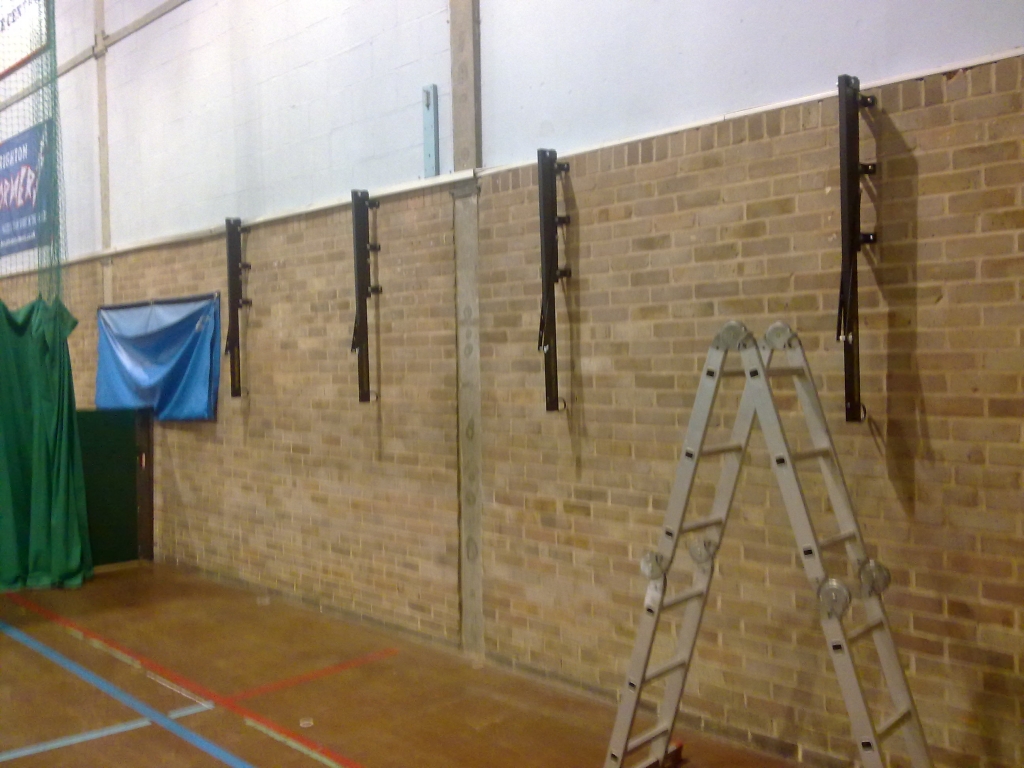 Brackets in a sports hall requiring protective covering