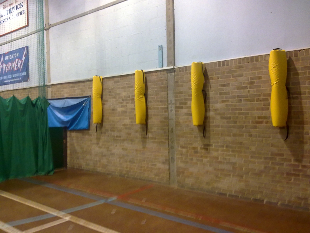 Protective covers for brackets in a sports hall