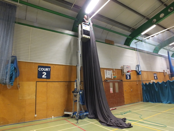 MDS Leisure use high lift machinery to assist with repairing sports arena nets and curtains 